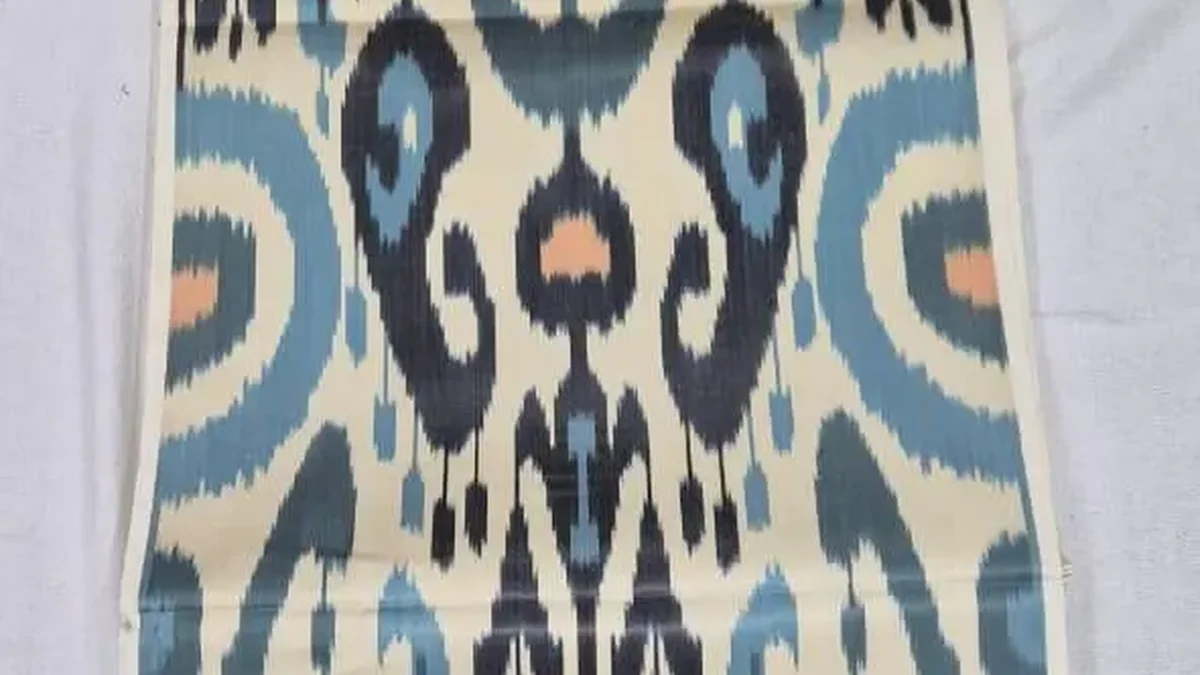 Blue and cream ikat fabric with softly feathered pattern edges, laid out flat