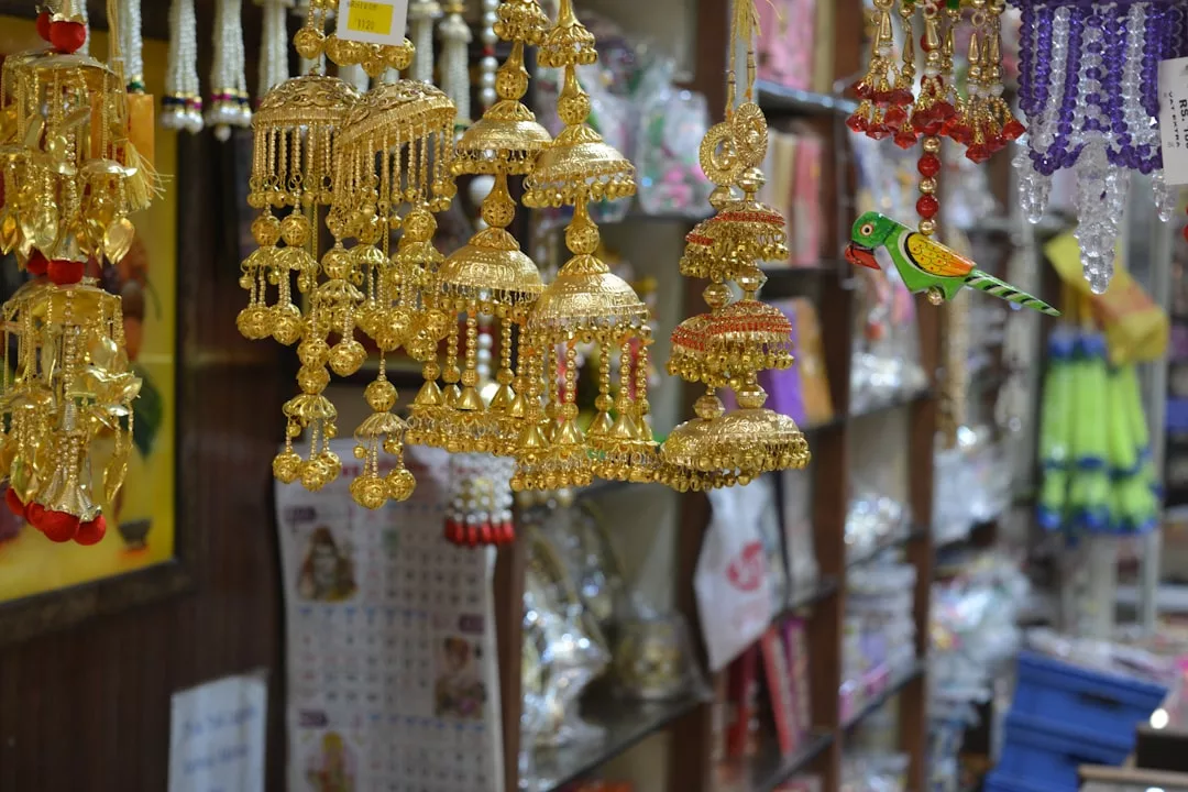 Golden hanging ornaments and colorful decorations on display in a shop near Santa Catalina, with shelves in the background—perfect for those exploring the area during gourmet food tours.