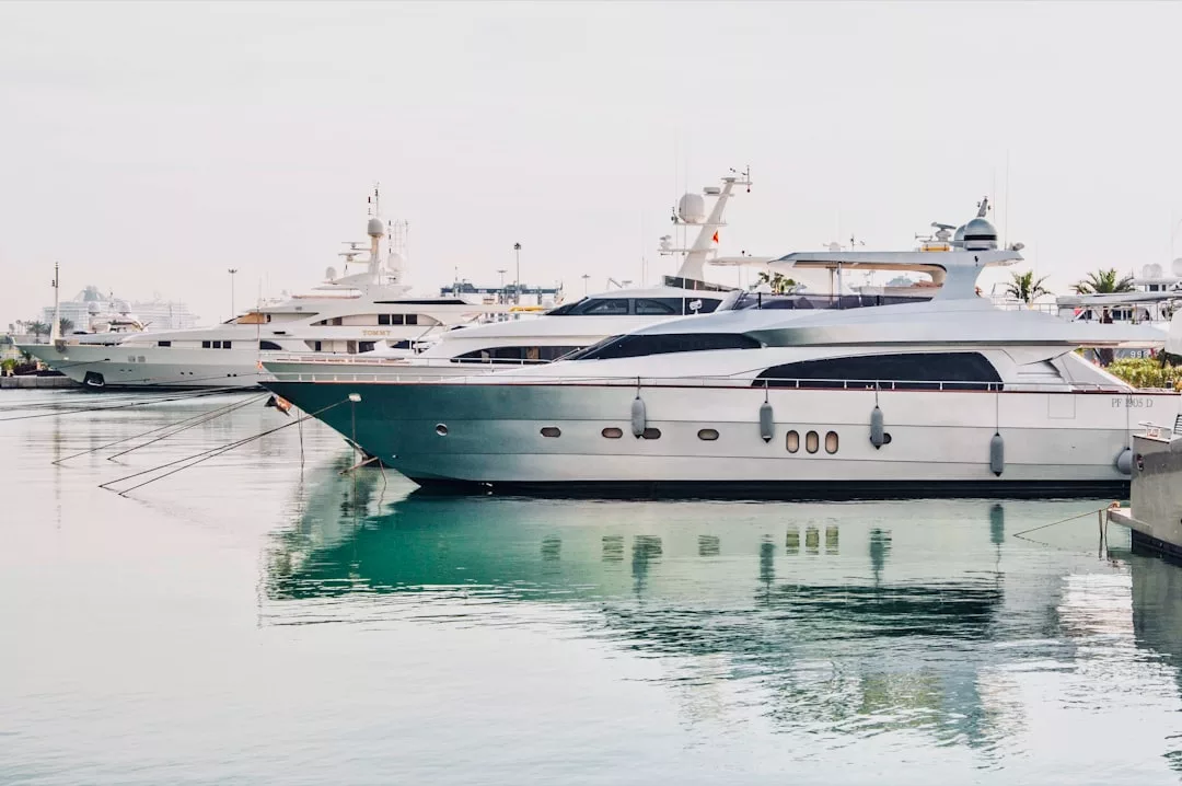 Luxury yachts docked in Port de Palma's marina with calm turquoise water and a clear, bright sky—perfect for unforgettable yacht dinners prepared by a private chef.