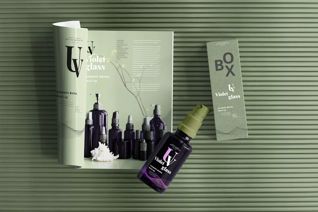 Purple cosmetic bottles and a box on a green striped surface, with an open magazine highlighting the same products—perfect for showcasing Deia villa marketing or illustrating villa sale strategies in style.