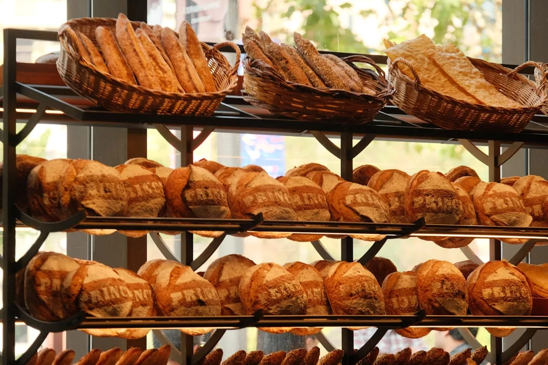 Shelves in a bakery in Majorca displaying round loaves of bread with 