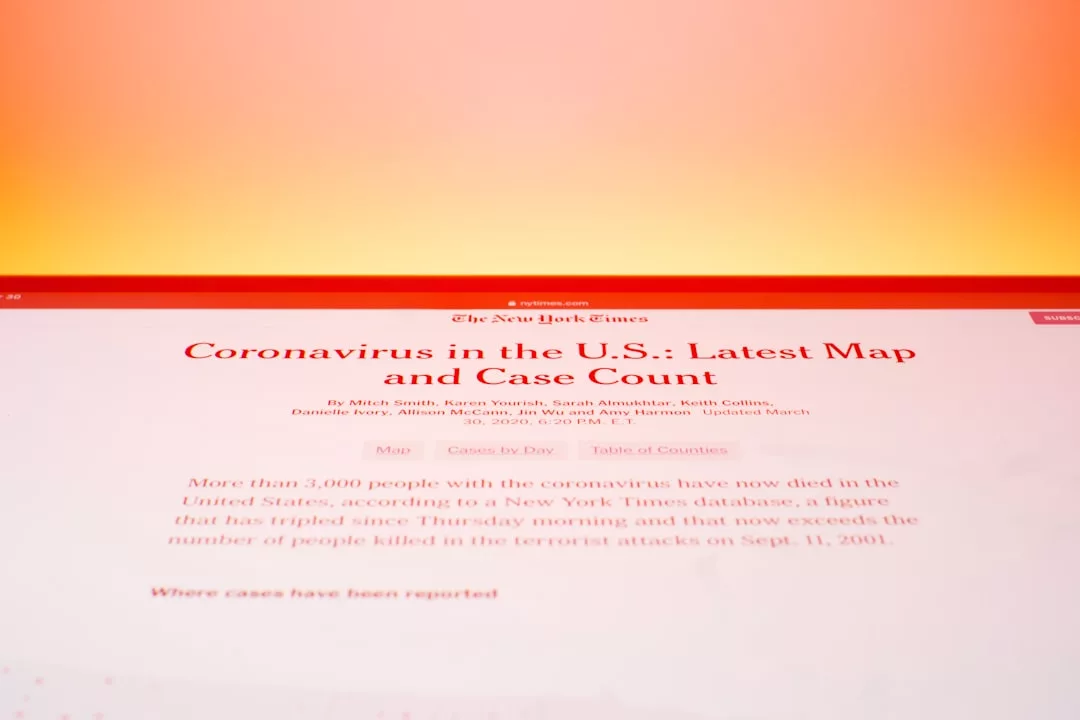 A computer screen displays a New York Times article titled 